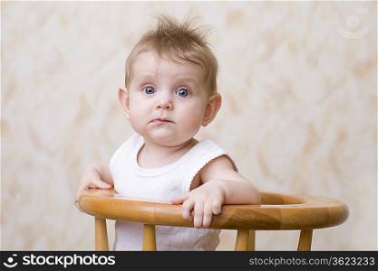 Baby boy sitting on high chair, portrait