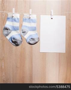 Baby boy socks attached to the rope and blank card for greetings