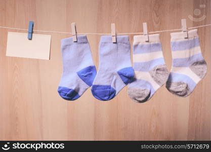 Baby boy socks attached to the rope and blank card for greetings