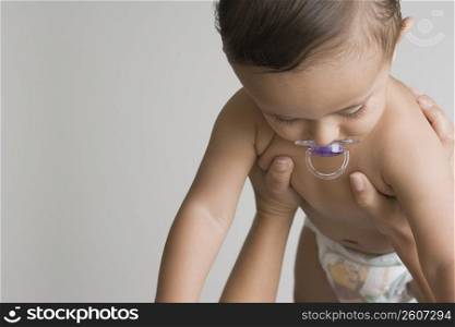 Baby boy sucking a pacifier