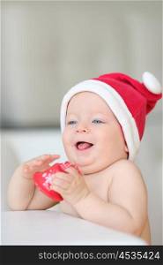 Baby boy with blue eyes christmas portrait in Santa Claus hat