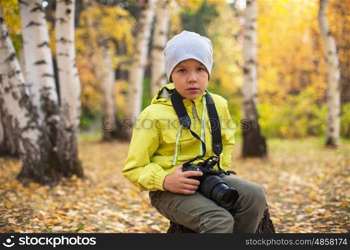 Baby boy with camera. Baby boy with camera in autumn forest