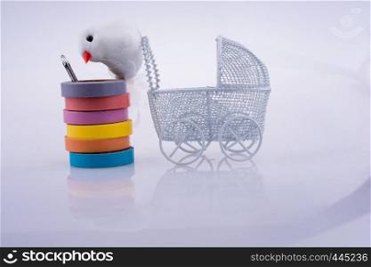 Baby carriage and a fake bird on a white background