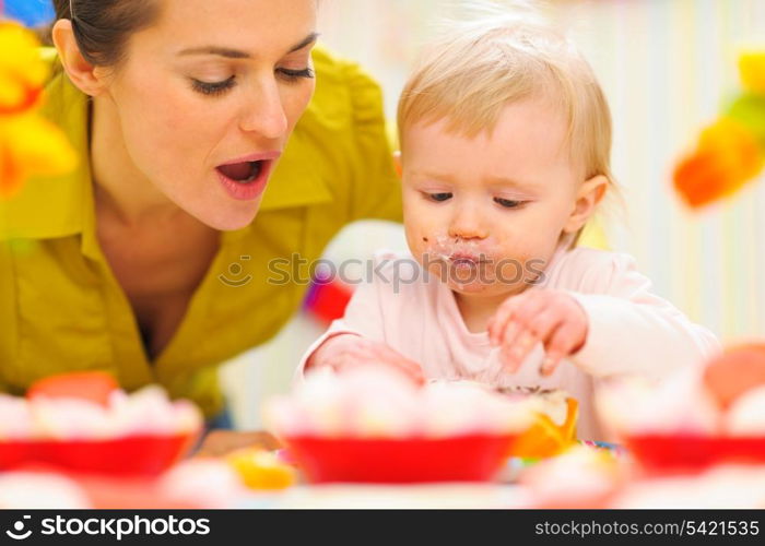 Baby celebrating first birthday with mom