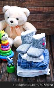 baby clothes and shoes on the wooden table