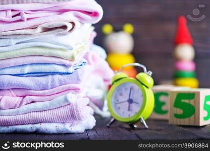 baby clothes and toys on a table