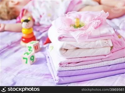 baby clothes on the bed, color baby linen