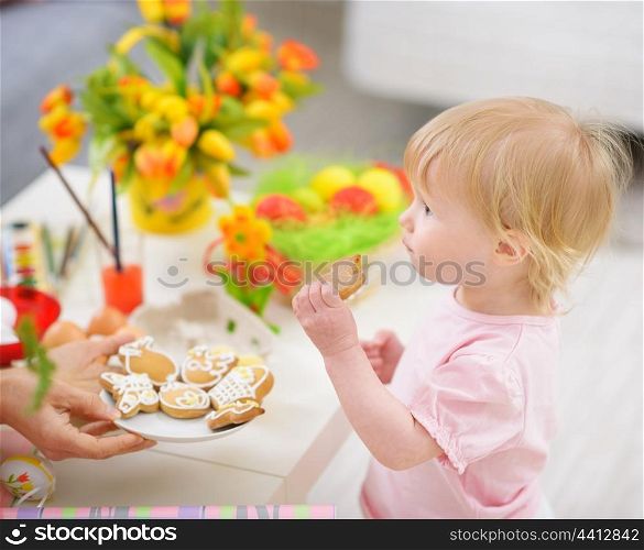 Baby eating Easter cookies
