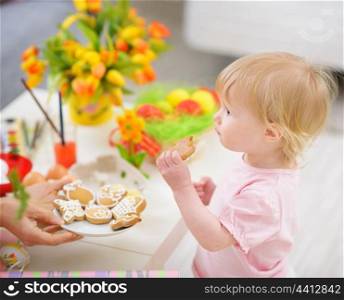 Baby eating Easter cookies