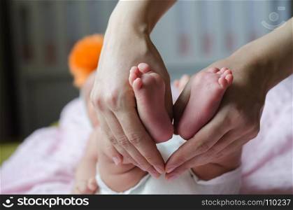 Baby feet in mother hands.baby is sleeping