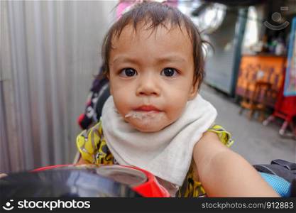 Baby girl after drink milk from glass.