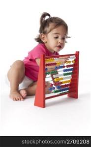 Baby girl counting with help of an abacus