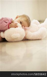 Baby Girl Cuddling Pink Teddy Bear At Home