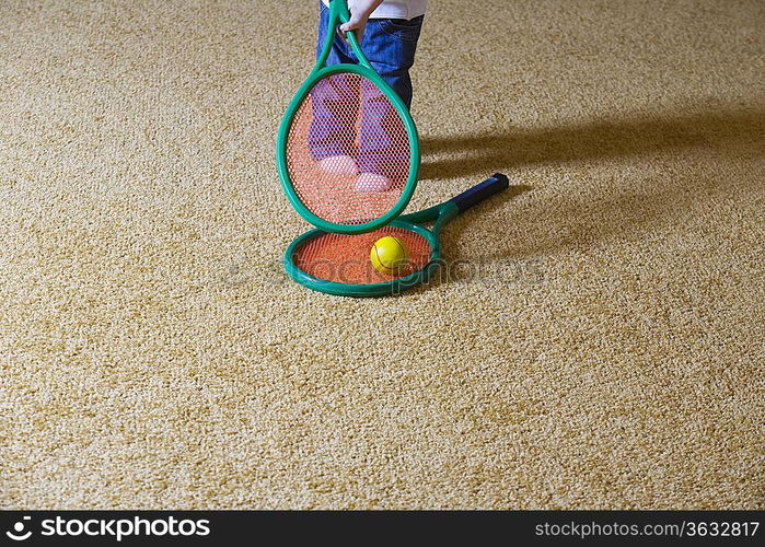 Baby girl holding tennis racket