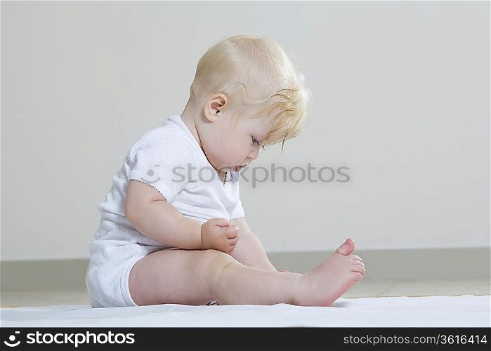 Baby girl playing on floor