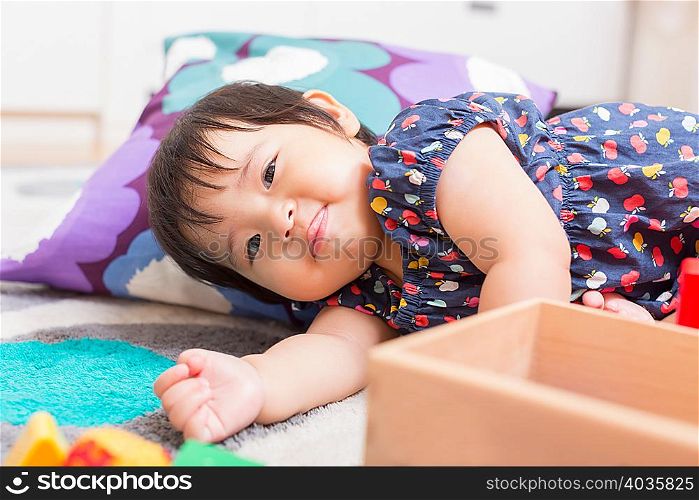 Baby girl playing on floor
