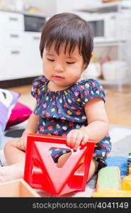 Baby girl playing on floor