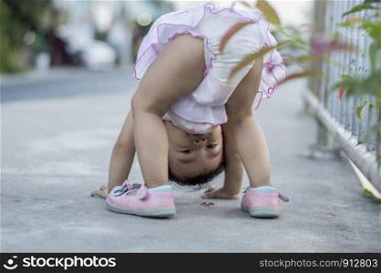 Baby girl playing upside down