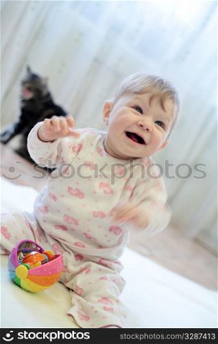 baby girl playing with smile expression indoors
