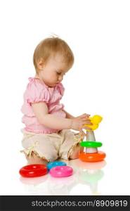 Baby girl playing with toys isolated on white