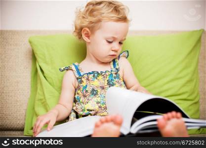 Baby girl reading a book