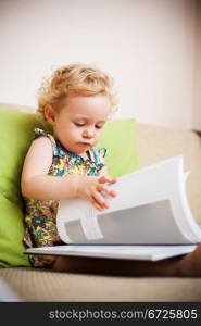 Baby girl reading a book