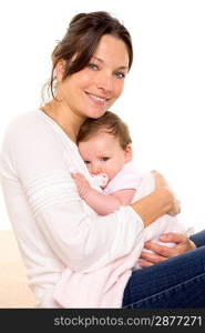 Baby girl relaxed with pacifier hug in mother arms on white background