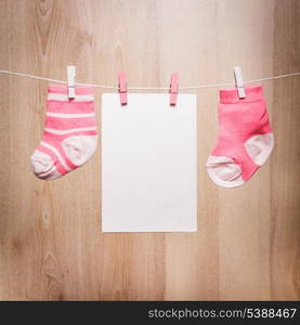 Baby girl socks attached to the rope and blank card