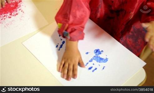 Baby girls, school and education, happy children having fun and painting with hands in kindergarten. Sequence