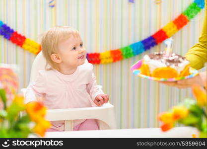 Baby happy to birthday cake