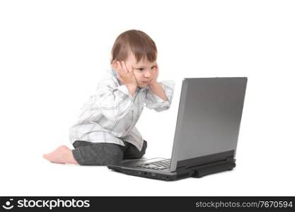 baby holding his head with laptop
