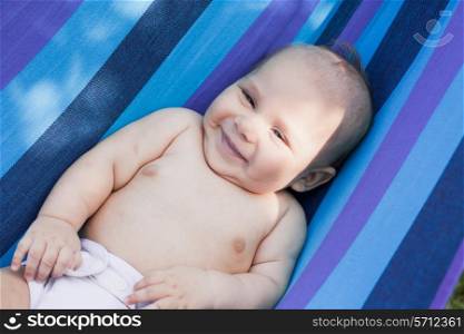 Baby in a hammock enjooys and relaxing