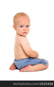 Baby in blue shorts, sitting on his knees on the white background