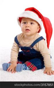 Baby in studio wearing christmas hat