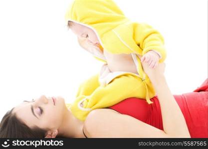 baby in yellow suit playing with mother
