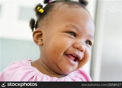 Baby indoors laughing