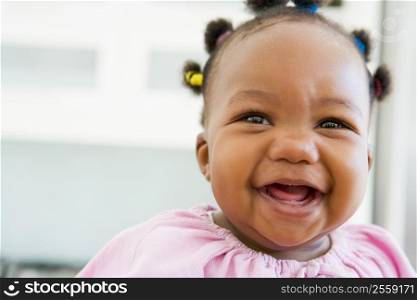 Baby indoors laughing
