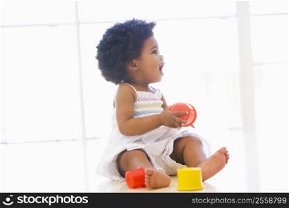 Baby indoors playing with cup toys