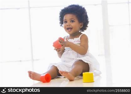 Baby indoors playing with cup toys