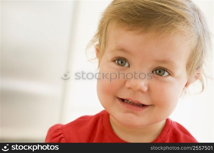 Baby indoors smiling