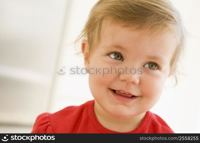 Baby indoors smiling