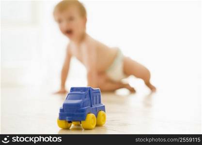 Baby indoors with toy truck