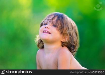 Baby kid girl smiling happy in summer on green field background