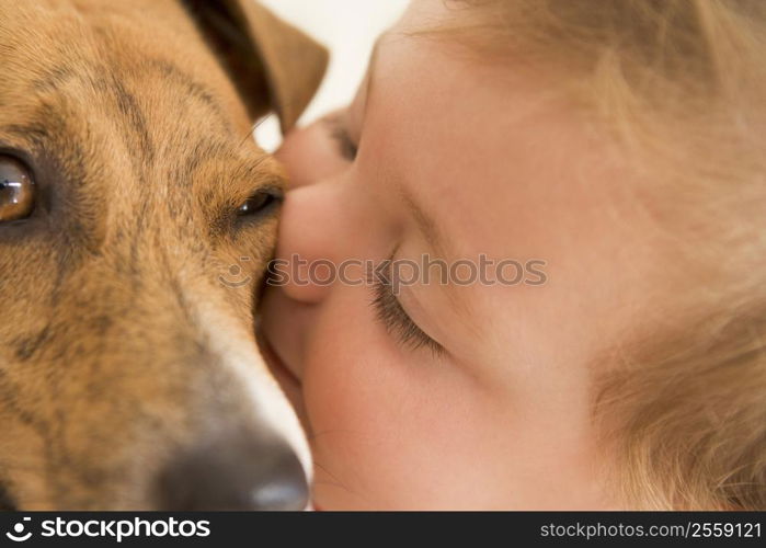 Baby kissing dog