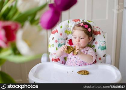 baby led weaning girl eating grilled chicken meatballs for lunch