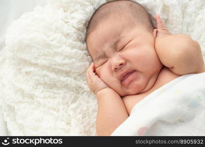 Baby lying on the bed