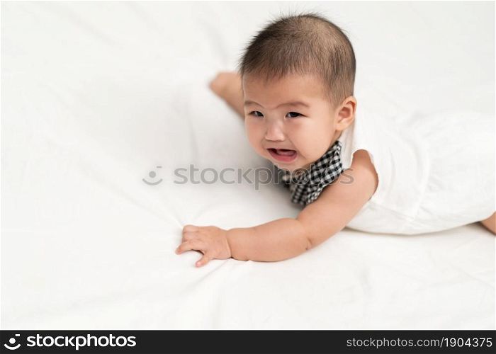 baby newborn crying on a bed