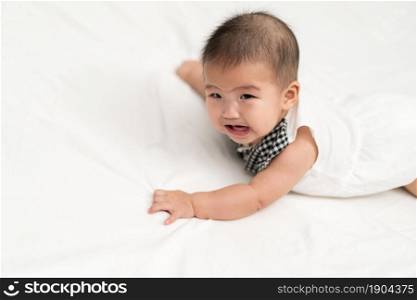 baby newborn crying on a bed