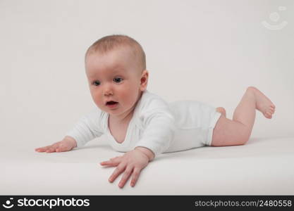 baby on a white background in a white pajamas. baby on a white background