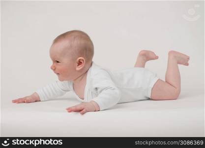 baby on a white background in a white pajamas. baby on a white background